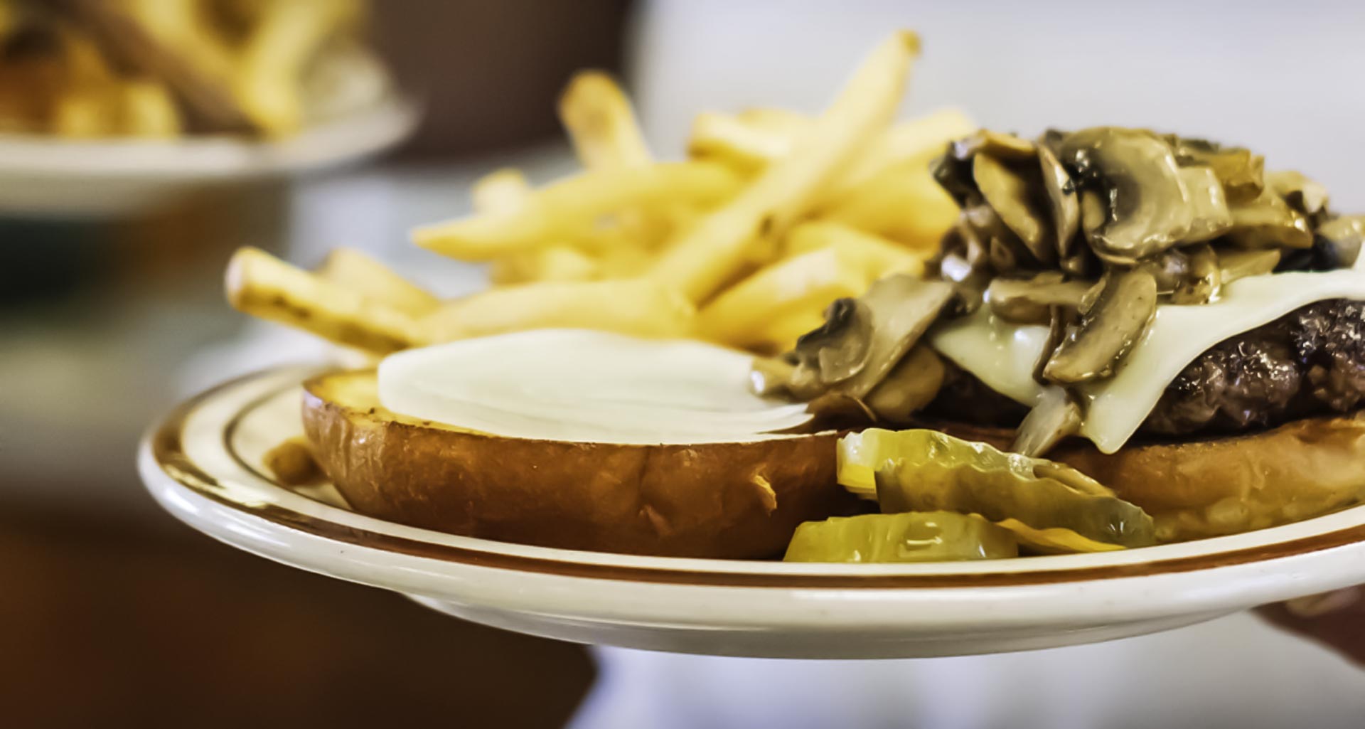 Mushroom and Swiss hamburger with fries.